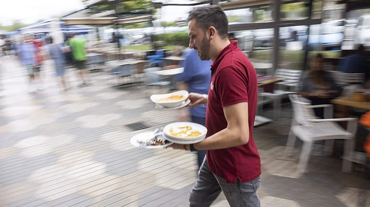 Camarero trabajando en restaurante tras jornada laboral y descanso de 12 horas entre turnos