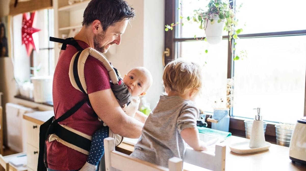 Padre cuidando a sus hijos en casa durante excedencia por cuidado de hijos