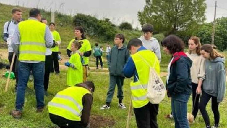 Profesional acompaña a un grupo de estudiantes durante una ruta educativa.