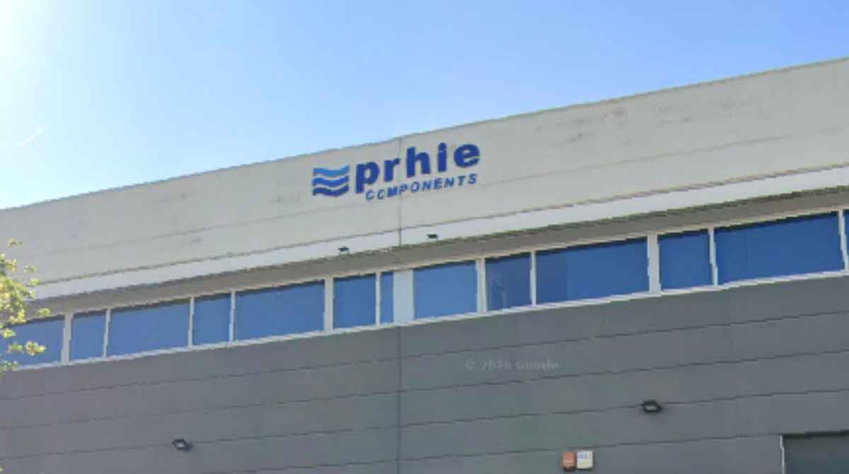 Fachada de una nave industrial con el rótulo de PRHIE Components.