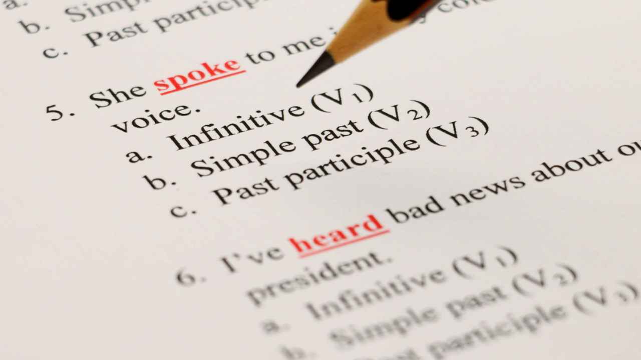 Lápiz sobre un ejercicio de gramática inglesa con preguntas sobre tiempos verbales.
